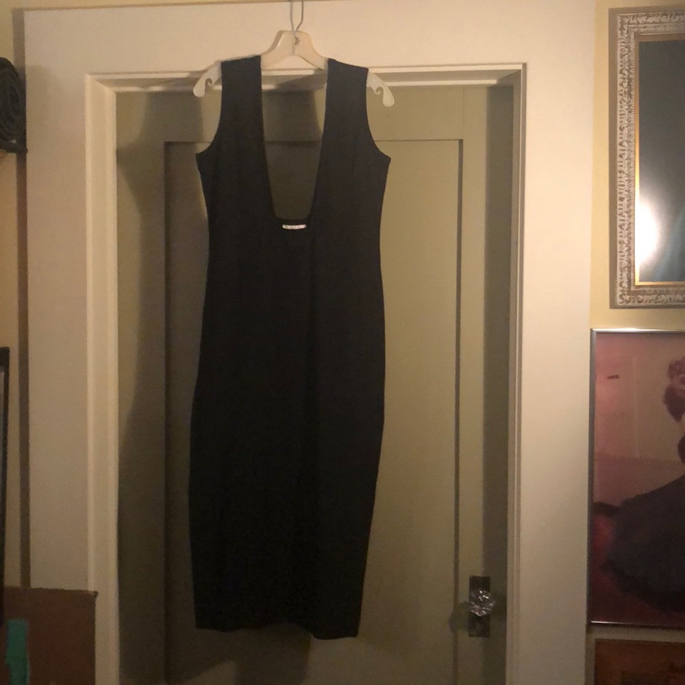 Comme Des Garçons black dress with low cut front.